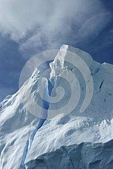 Tip of an iceberg against a blue sky Antarctic summer.