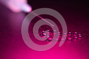 The tip of the syringe with a drop