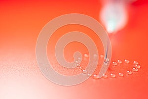 The tip of the syringe with a drop