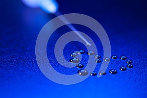 The tip of the syringe with a drop