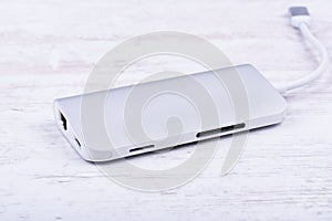 Tipe-C aluminum multiport adapter on white wooden background