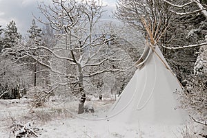 A tipi covered in snow in winter