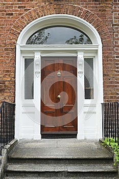 A tipical brownwooden door in Dublin of a victorian house photo