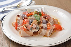 Tipical sud italian dish with swordfish capper tomato basil oliva oil mediterranean food
