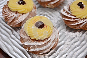 Tipical sweet italian dessert zeppole of san giuseppe day festivity event pie with cream cherry