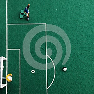 Tipp kick soccer parlor game with green background a goalkeeper in a goal and a football player photo
