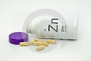 Tipped over bottle of Zinc vitamins photo