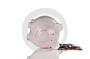 Tipped over piggy bank with change for financial crisis concept