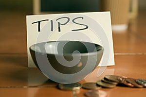 Tipping bowl in coffee shop with coins