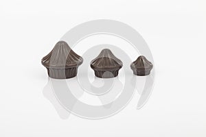 Tips of brown plastic for curtain poles on white background