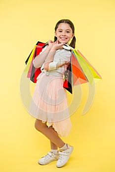 Tips to save money on back to school supplies and clothing. Back to school season teach budgeting basics. Girl carries