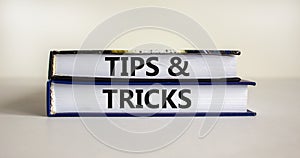 Tips and tricks symbol. Books with words `Tips and tricks`. Beautiful white background. Business, tips and tricks concept. Copy