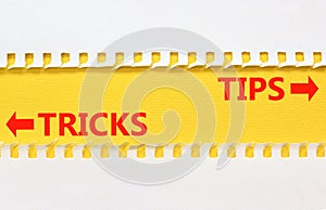 Tips and tricks symbol. Concept word Tips and tricks on beautiful yellow paper. Beautiful white paper background. Business and
