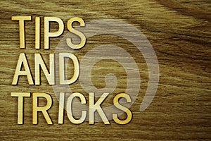 Tips and Tricks text message on wooden background