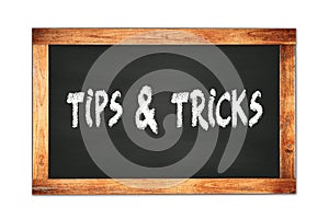 TIPS  &  TRICKS text written on wooden frame school blackboard