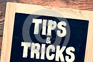 TIPS AND TRICKS words on a chalkboard