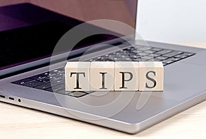 TIPS word on wooden block on laptop, business concept