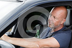 Tipsy man on steering wheel photo