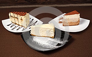 Tiramisu and chocolate cheesecake on a dark background