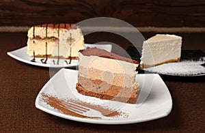 Tiramisu and chocolate cheesecake on a dark background