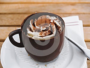 Tiramisu chocolate cup on a white plate served on a wooden table
