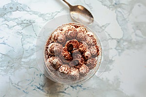 Tiramisu dessert with home delivery. Take and go food. Delivery. A plastic cup.Copy space. Top view