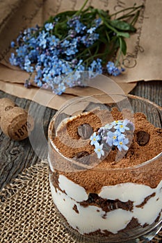 Tiramisu in a glass, blue flowers forget-me-nots.