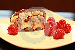 Tiramisu on plate with raspberries