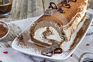 tiramisu roulade on white cocoa tray