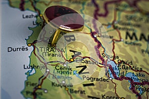 Tirana pinned on a map with flag of Albania