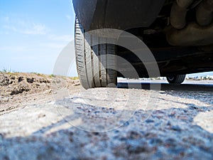 Tire and alloy wheel of a modern car on the ground. Car exterior details. Car detailing