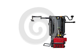 Tire changer for seasonal change of car tires and repair of punctures and cuts in a auto service on a white isolated background.