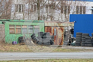 A tire fitting workshop of two old rusty metal trailers