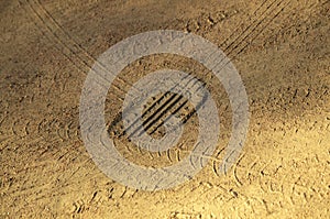 Tire footprint on yellow sand close up