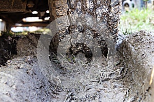Tire in the mud. Tire tracks on wet ground