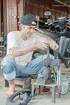 Tire patcher holds the press before patching the leaky inner tube