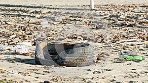 Tire, plastic bottles and other garbage symbol of serious pollution