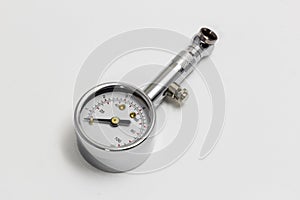 Tire pressure gauge on white background