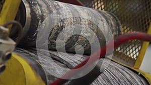 Tire production. Rubber tape on a rolling machine.