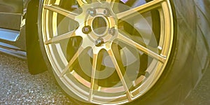 Tire rim with disc brake seen between gold spokes