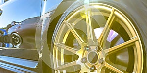 Tire rim with golden spokes of a reflective car