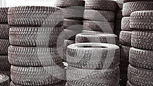 Tire stack background. car tires stacked one on top of another in a warehouse