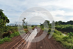 Tire track of many vehicle on soil mud road in countryside in rainy season