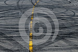 Tire track mark on asphalt tarmac road race track texture and background, Abstract background black tire tracks skid on asphalt