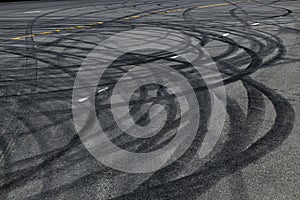 Tire track mark on asphalt tarmac road race track texture and background, Abstract background black tire tracks skid on asphalt