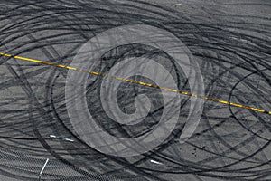 Tire track mark on asphalt tarmac road race track texture and background, Abstract background black tire tracks skid on asphalt