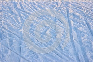 Tire tracks on clean, white snow on a Sunny and frosty winter day. chaotic motion