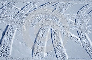 Tire tracks crossing the snowy terrain