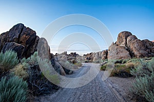 Tire tracks desert sand road the Alabama Hills rock formations Sierra Nevada California