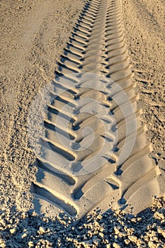 Tire tracks of excavator in sand
